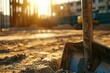 Close-up of a weathered concrete shovel with fresh concrete, in the golden light of an afternoon at a well-organized construction site