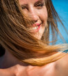 Woman smiling perfect smile.Woman flying hair enjoying, outdoor. Beauty blonde girl portrait at summer. Perfect hair, shampoo. Smiling woman perfect look, bright blond hair