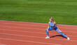 © Yevhen - Girl athlete do sport workout. Trainer or coach training. Female runner stretching before workout. Sports exercises and stretching in the stadium. Physical training girl. Fit girl do outward lunging
