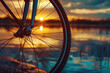View through the wheel of a bicycle at sunset