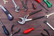 Diverse of serviceman tools for repair work on wooden workshop. View from above.