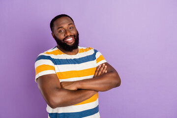 Wall Mural - Photo of cheerful good mood man wear striped t-shirt arms crossed empty space isolated violet color background