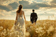 Young happy wedding couple walking in the field