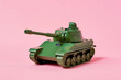 Green tank toy model, Isolated on neutral pink background