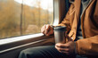 Traveling concept: man enjoying a hot beverage on a bus trip.