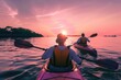 © Attasit - Two people kayaking in a lagoon at sunset