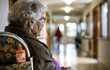 Elderly woman sitting alone in wheelchair in nursing home