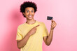 © deagreez - Photo of funky pretty man wear yellow t-shirt pointing finger bank card isolated pink color background