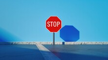 A Red Stop Sign Stands On The Ground Against A Blue Background, With Large Text STOP In The Style Of Minimalism It Is A High Resolution Photograph With High Detail And High Quality.