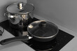 induction two-burner surface, a frying pan and a saucepan are on the stove in the apartment