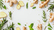 Fresh ginger root, sliced lemon, and aromatic herbs including mint and rosemary, artistically arranged on a white background, ideal for culinary and health content.