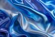 Blue and silver silk satin fabric background with soft folds