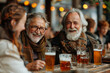 Unknown people smiling and chatting together with a glass of fresh brewed beer at the table of a Bavarian beer garden