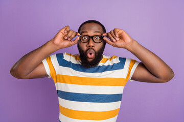 Wall Mural - Photo of excited impressed man wear striped t-shirt arms spectacles isolated violet color background