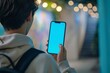 © Markus Schröder - Screen display over shoulder of a teen boy holding an smartphone with a completely blue screen