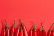 © Foodlovers - Red hot chilli peppers on minimal red background
