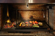 © Foodlovers - A flaming charcoal grill, with a selection of meat and vegetables