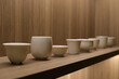 various traditional Chinese teacups in a row on shelf