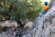 © zhukovvvlad - the mother will protect the baby while climbing. lesson with a trainer, children's climbing training.