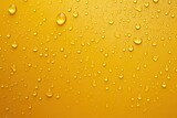 Fototapeta Kwiaty - Water droplets on a yellow surface