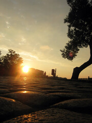 Wall Mural - Paving stones close-up against the backdrop of sunset in the city	
