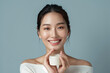 A woman is holding a white cream container and smiling. Concept of happiness and contentment, as the woman is enjoying her time