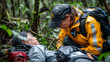 An Asian female climber lay injured on the ground. And the medical staff inquired about her condition and treated her. rainforest background