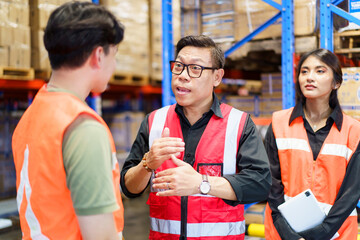 Warehouse workers talking and discussing together during the morning brief.