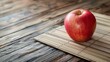 A red apple on bamboo mat on table