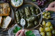 Eating Traditional Turkish Dolma, Sarma or Dolmades with Tzatziki Sauce, Mediterranean Dish