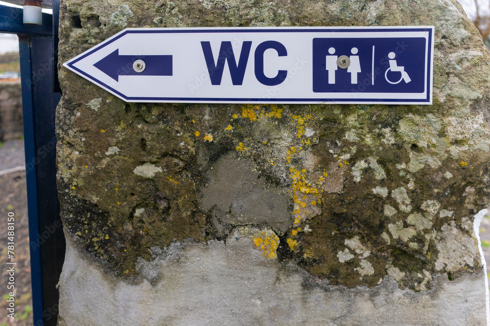 ภาพถ่าย Stock Accessible restroom sign depicting both standard and ...