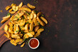 Delicious potato wedges on the black background