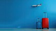 Vibrant blue backdrop, luggage, plane. Adventure awaits. Capture wanderlust.