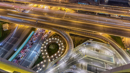 Wall Mural - Aerial view of highway interchange in Dubai downtown night timelapse.