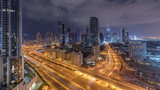 Fototapeta Miasto - Skyline view of the buildings of Sheikh Zayed Road and DIFC night to day timelapse in Dubai, UAE.