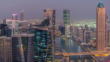 Fototapeta Miasto - Aerial skyline of Dubai's business bay with skyscrapers day to night timelapse