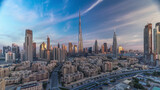 Fototapeta Miasto - Dubai Downtown skyline timelapse with Burj Khalifa and other towers during sunrise panoramic view from the top in Dubai