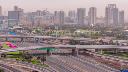 Wall Mural - Dubai Golf Course with a cityscape of Greens and tecom districts at the background aerial timelapse
