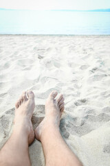 Wall Mural - beautiful legs in the sand of the sea greece background