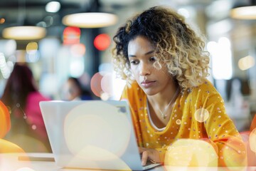 Poster - A businesswoman is deeply focused as she works on her laptop in a bustling modern office setting