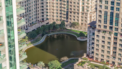 Wall Mural - Manmade lake and residential buildings in Greens neighborhood timelapse in Dubai, UAE