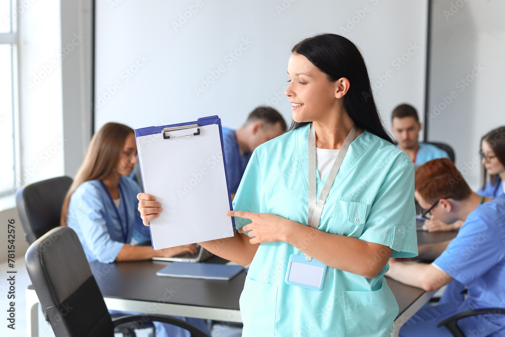 Female medical student with clipboard at university