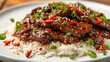 Mongolian beef with sweet and savory spicy soy sauce and garlic glaze served on rice. Popular Asian dish