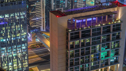Wall Mural - Skyline of the buildings of Sheikh Zayed Road and DIFC aerial night timelapse in Dubai, UAE.