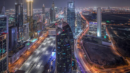 Poster - Skyline of the buildings of Sheikh Zayed Road and DIFC aerial night timelapse in Dubai, UAE.