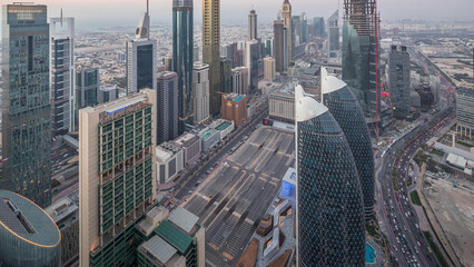 Wall Mural - Skyline of the buildings of Sheikh Zayed Road and DIFC aerial day to night timelapse in Dubai, UAE.