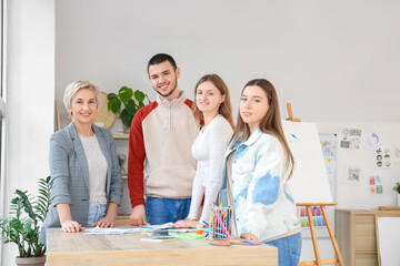 Wall Mural - Young students with teacher during lesson in art school