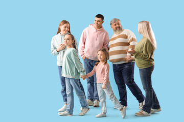 Wall Mural - Big family holding hands on blue background