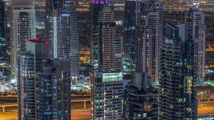 Wall Mural - Dubai Marina skyscrapers and jumeirah lake towers view from the top aerial night timelapse in the United Arab Emirates.