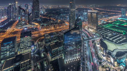 Wall Mural - Dubai International Financial Centre district with modern skyscrapers night timelapse